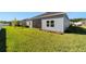 View of the backyard with a screened patio and grassy lawn at 7930 Sw 74Th Loop, Ocala, FL 34481