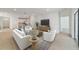 Open concept living room and kitchen with light wood flooring and white furniture at 7930 Sw 74Th Loop, Ocala, FL 34481