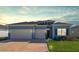 Two-story home with light blue siding and two-car garage at 7930 Sw 74Th Loop, Ocala, FL 34481