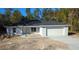 Newly constructed one-story home with gray exterior, attached garage, and concrete driveway at 90 Bay Dr, Ocklawaha, FL 32179