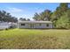 Large backyard with grassy area and home view at 9554 Bahia Rd, Ocala, FL 34472