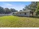 Spacious backyard with grassy area and home view at 9554 Bahia Rd, Ocala, FL 34472