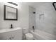 Bathroom with white vanity, toilet, and marble-tiled shower/tub at 9554 Bahia Rd, Ocala, FL 34472