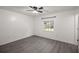 Bedroom with ceiling fan, large window, and wood-look flooring at 9554 Bahia Rd, Ocala, FL 34472