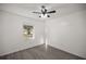 Spacious bedroom with ceiling fan and large window at 9554 Bahia Rd, Ocala, FL 34472