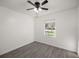 Bright bedroom with gray vinyl flooring and a ceiling fan at 9554 Bahia Rd, Ocala, FL 34472