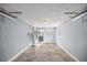 Attached garage with concrete floor and storage racks at 9554 Bahia Rd, Ocala, FL 34472