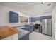 Modern kitchen featuring blue cabinets and stainless steel appliances at 9554 Bahia Rd, Ocala, FL 34472