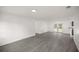 Spacious living area with gray flooring and access to backyard at 9554 Bahia Rd, Ocala, FL 34472