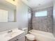 Bathroom with white vanity, tub and tiled shower at 17 Locust Lane Ter, Ocala, FL 34472