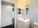 Bathroom with white vanity and mirror at 17 Locust Lane Ter, Ocala, FL 34472