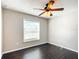 Bright bedroom with dark hardwood floors and ceiling fan at 17 Locust Lane Ter, Ocala, FL 34472