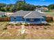 Rear view of house, showcasing patio and yard at 17 Locust Lane Ter, Ocala, FL 34472