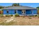Back of house with covered patio and landscaping at 17 Locust Lane Ter, Ocala, FL 34472