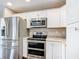 Modern kitchen with stainless steel appliances and white cabinets at 17 Locust Lane Ter, Ocala, FL 34472