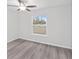 Bedroom with vinyl flooring, ceiling fan and large window at 175 Fisher Way Trl, Ocklawaha, FL 32179
