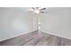 Bright bedroom with ceiling fan and vinyl flooring, access to hallway at 175 Fisher Way Trl, Ocklawaha, FL 32179