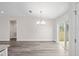 Dining area featuring hardwood floors and a chandelier, with access to backyard at 175 Fisher Way Trl, Ocklawaha, FL 32179