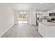 Bright dining area with vinyl flooring and sliding glass doors leading to the backyard at 175 Fisher Way Trl, Ocklawaha, FL 32179