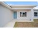 Front porch with teal door and window, offering curb appeal at 175 Fisher Way Trl, Ocklawaha, FL 32179