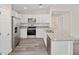 Modern kitchen with white cabinets, granite countertops and stainless steel appliances at 175 Fisher Way Trl, Ocklawaha, FL 32179