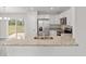 Kitchen island with granite countertop, stainless steel sink and appliances at 175 Fisher Way Trl, Ocklawaha, FL 32179