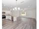 Open concept kitchen with stainless steel appliances and granite countertops at 175 Fisher Way Trl, Ocklawaha, FL 32179