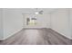 Bright living room with grey flooring, a ceiling fan, and a window at 175 Fisher Way Trl, Ocklawaha, FL 32179