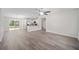Open concept living area featuring a kitchen island and vinyl flooring at 175 Fisher Way Trl, Ocklawaha, FL 32179