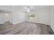 Living room with grey flooring, a view into bathroom, and white interior at 175 Fisher Way Trl, Ocklawaha, FL 32179