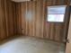 Bedroom with wood paneled walls and tile flooring at 2103 Parkview Ave, Leesburg, FL 34748