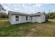 Side view of the house with a white door and shutters at 30 Maple Crse, Ocklawaha, FL 32179