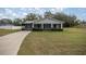 Newly constructed home with a screened porch and landscaped lawn at 30 Maple Crse, Ocklawaha, FL 32179