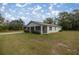 Single-story home with a screened porch and large backyard at 30 Maple Crse, Ocklawaha, FL 32179