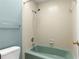 Clean bathroom with a teal tub and shower combination at 330 Ne 45Th Ter, Ocala, FL 34470