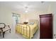 Bedroom with a brass bed frame and wooden armoire at 5336 Sw 109Th Place Rd, Ocala, FL 34476