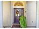 Inviting front entrance with a decorative wreath and potted plant at 5336 Sw 109Th Place Rd, Ocala, FL 34476