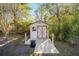 Inviting storage shed with deck and surrounding trees at 5336 Sw 109Th Place Rd, Ocala, FL 34476