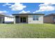 View of backyard with covered patio and lush lawn at 6119 Sw 93Rd Cir, Ocala, FL 34481