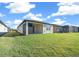 Landscaped backyard with view of covered patio and community at 6119 Sw 93Rd Cir, Ocala, FL 34481