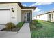 Front door entry with a screened porch and nicely landscaped walkway at 6119 Sw 93Rd Cir, Ocala, FL 34481
