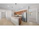 Open kitchen with island, stainless steel appliances, and wood cabinets at 6119 Sw 93Rd Cir, Ocala, FL 34481