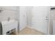 Laundry room with utility sink, cabinets and door to exterior at 6119 Sw 93Rd Cir, Ocala, FL 34481