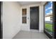 Small screened porch with a black front door and a window at 6119 Sw 93Rd Cir, Ocala, FL 34481
