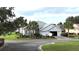 Single-story home with a two-car garage, mature landscaping, and curb appeal at 8616 Sw 82Nd Ter, Ocala, FL 34481