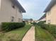 Brick pathway between condo buildings with green lawns at 1100 E Caroline St # 216, Tavares, FL 32778