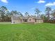 Single-story house with a neutral exterior, stone accents, and a lush lawn at 12724 Sw 78Th Pl, Dunnellon, FL 34432