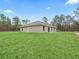 Single-story home with a large grassy yard at 12724 Sw 78Th Pl, Dunnellon, FL 34432