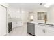 Modern kitchen with white cabinets, wine cooler, and a large island at 2350 Nw 59Th Ave, Ocala, FL 34482