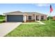 Newly built home with a two-car garage and well-manicured lawn at 28 Juniper Pass Dr, Ocala, FL 34480